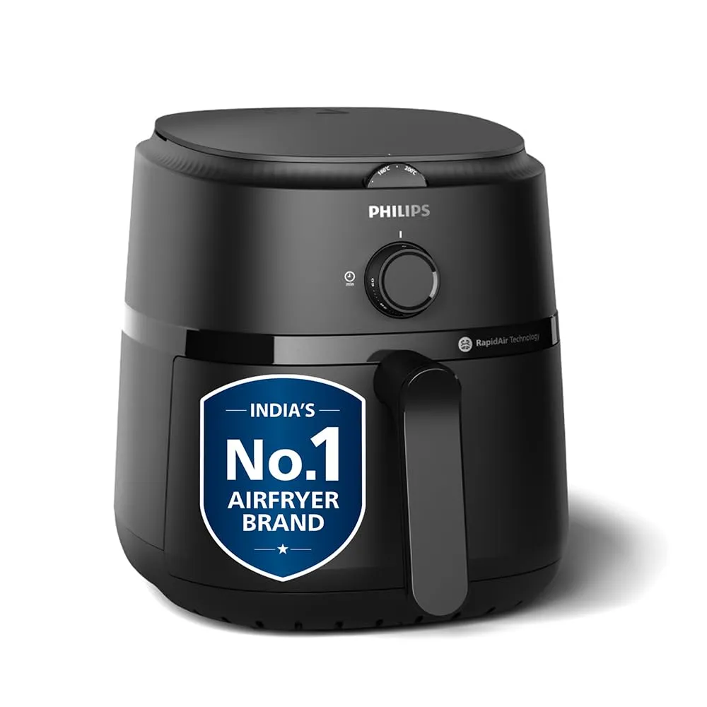 A close-up of a modern air fryer in a clean Indian kitchen preparing crispy paneer tikka.