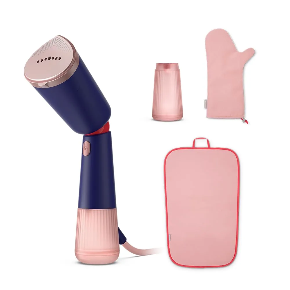 Handheld garment steamer on a wooden table with clothes