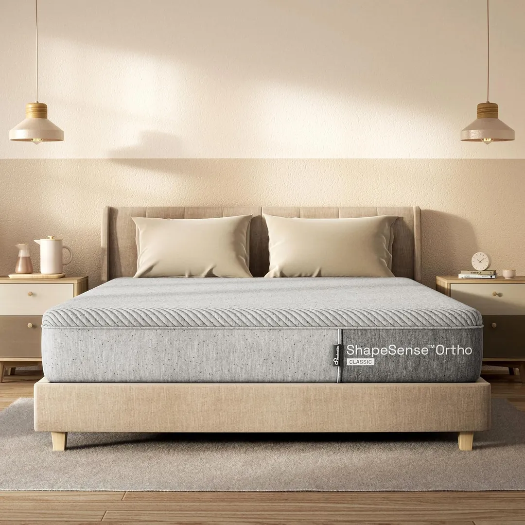 Neatly made bed with a supportive mattress