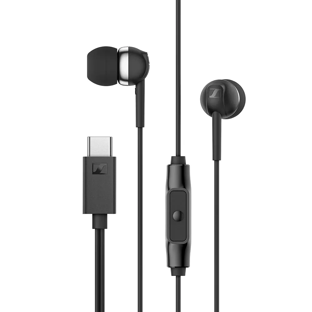 Collection of wired earphones neatly coiled on a wooden desk next to a smartphone